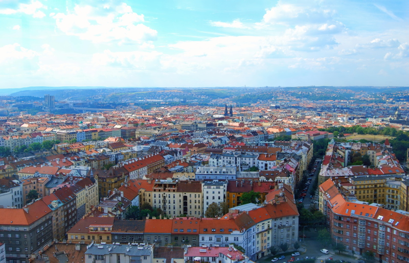 20 - A sweeping view of Prague's dense urban landscape and distinctive red-tiled roofs, captured from the Žižkov Television Tower